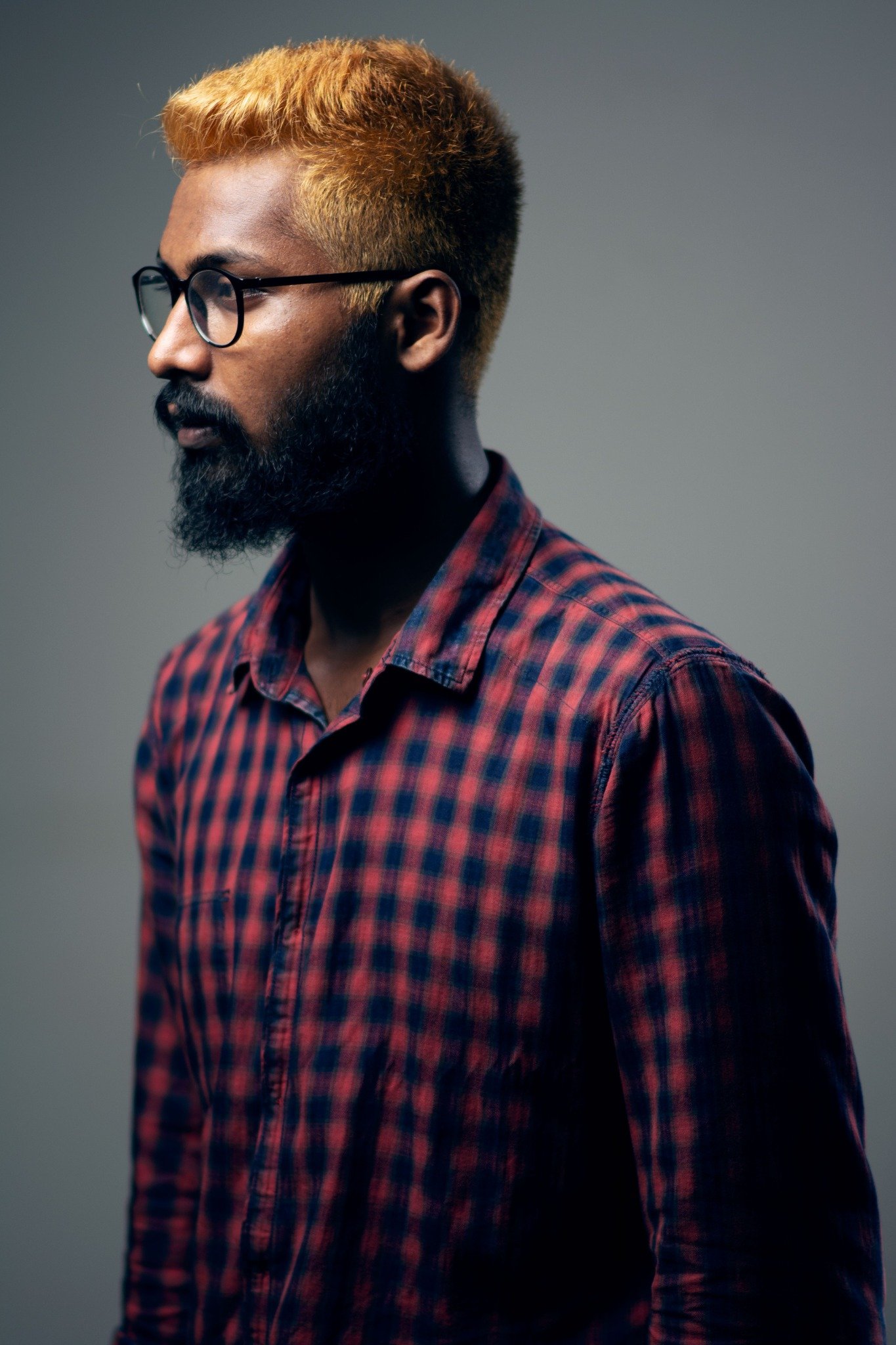Team member in a plaid shirt and glasses